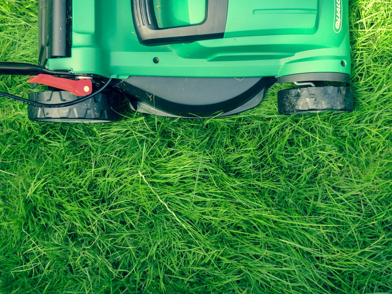 Lawn mower on a maintained grass lawn